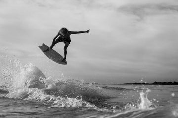 blair conklin doing an air on an exile skimboard blairacuda